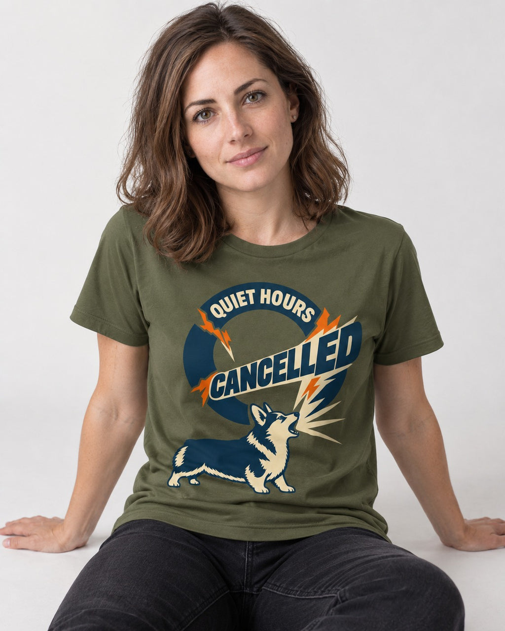 Corgi Quiet Hours Cancelled Calling Badge Graphic T-Shirt in Heather Military Green, worn by a seated model