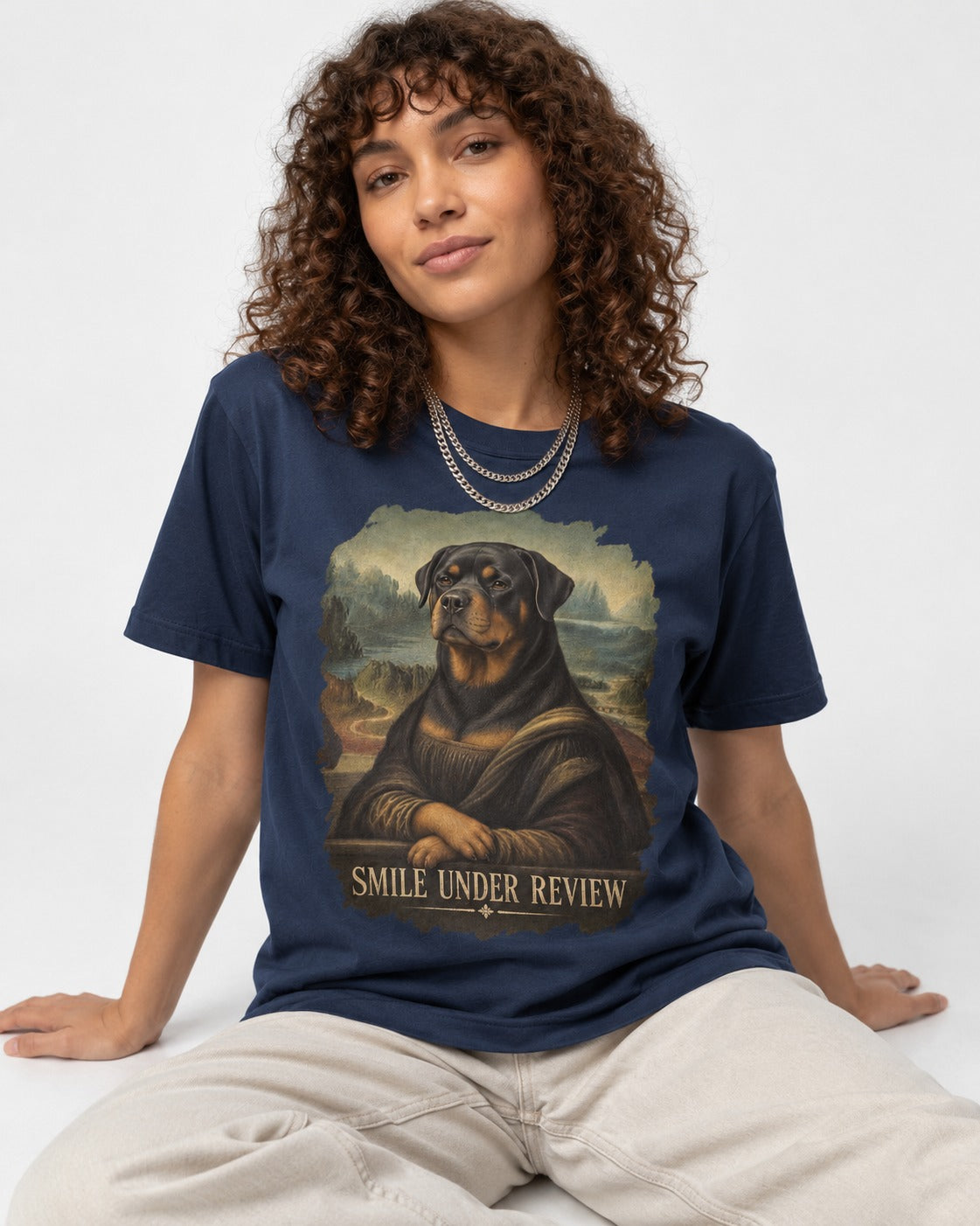 Rottweiler Smile Under Review Renaissance Portrait Graphic T-Shirt in Navy, worn by a seated model