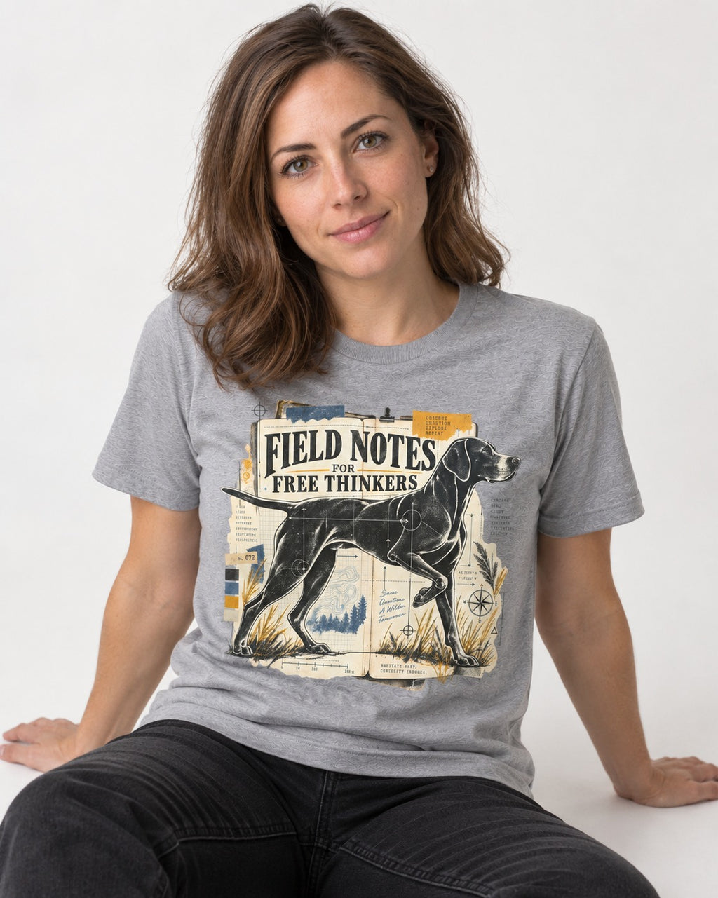 Field Notes for Free Thinkers Collage German Shorthaired Pointer Graphic T-Shirt in Sport Grey, worn by a seated model