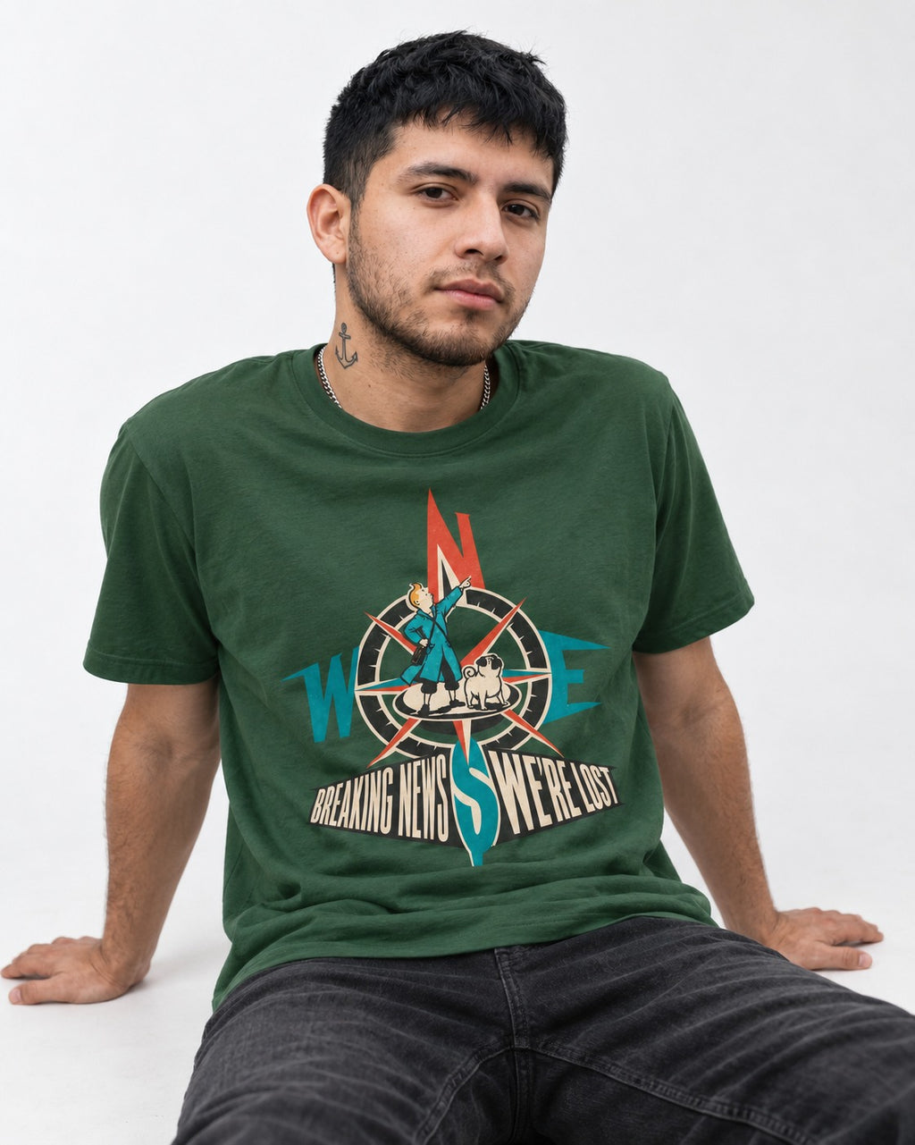 Pug Breaking News We're Lost Compass Graphic T-Shirt in Forest Green, worn by a seated model