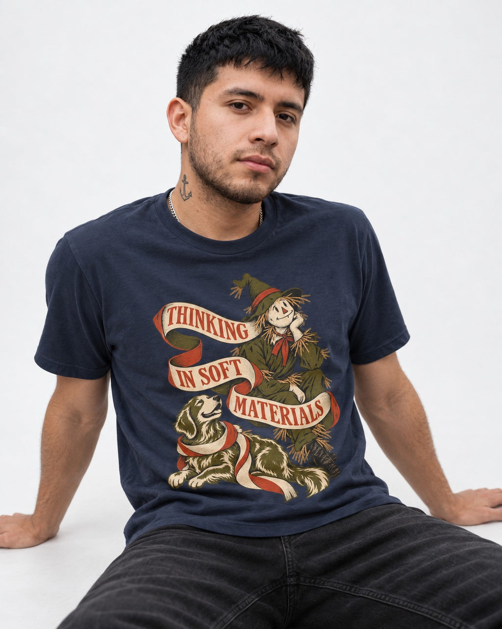 Golden Retriever Thinking in Soft Materials Scarecrow Graphic T-Shirt in Navy, worn by a seated model