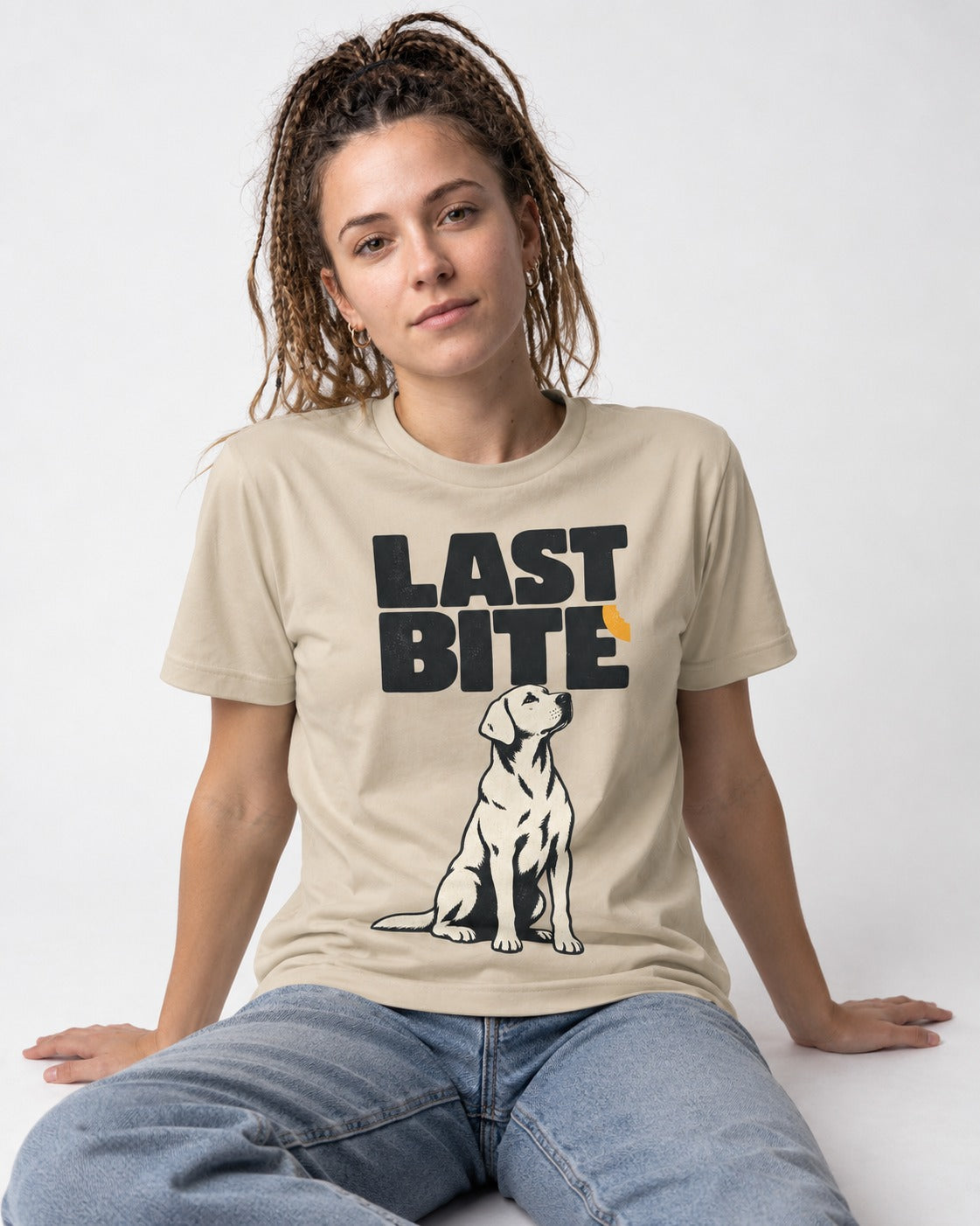 Labrador Retriever's Last Bite T-Shirt in Sand, worn by a seated model