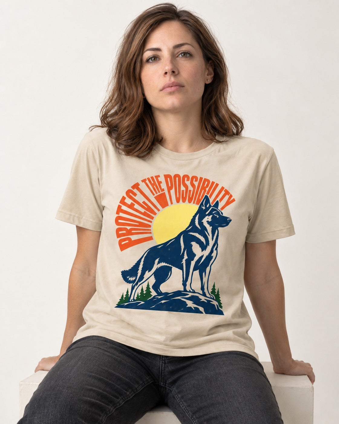 German Shepherd Dog Protect the Possibility T-Shirt in Sand, worn by a seated model