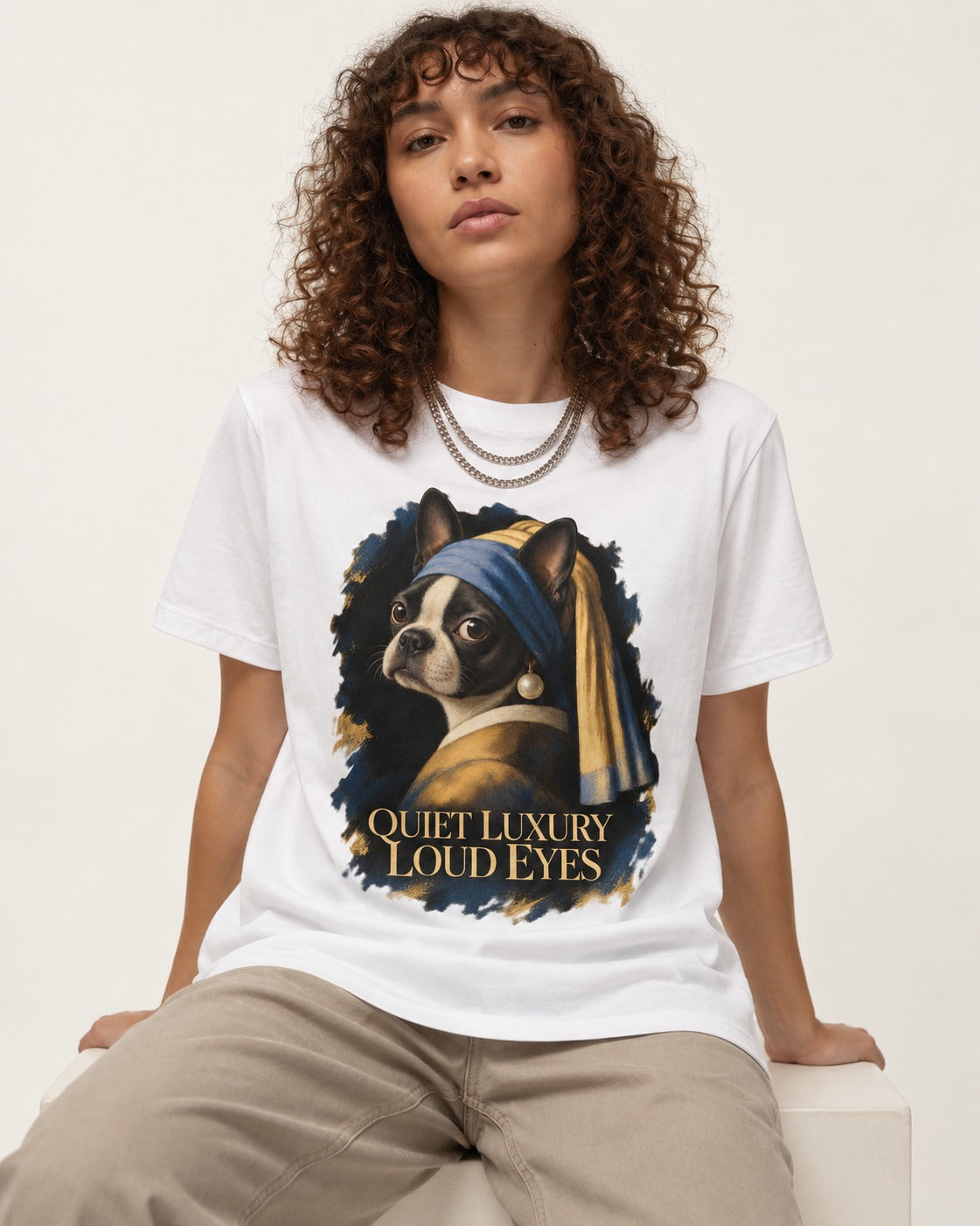 Quiet Luxury Loud Eyes Boston Terrier Pearl Portrait T-Shirt in White, worn by a seated model