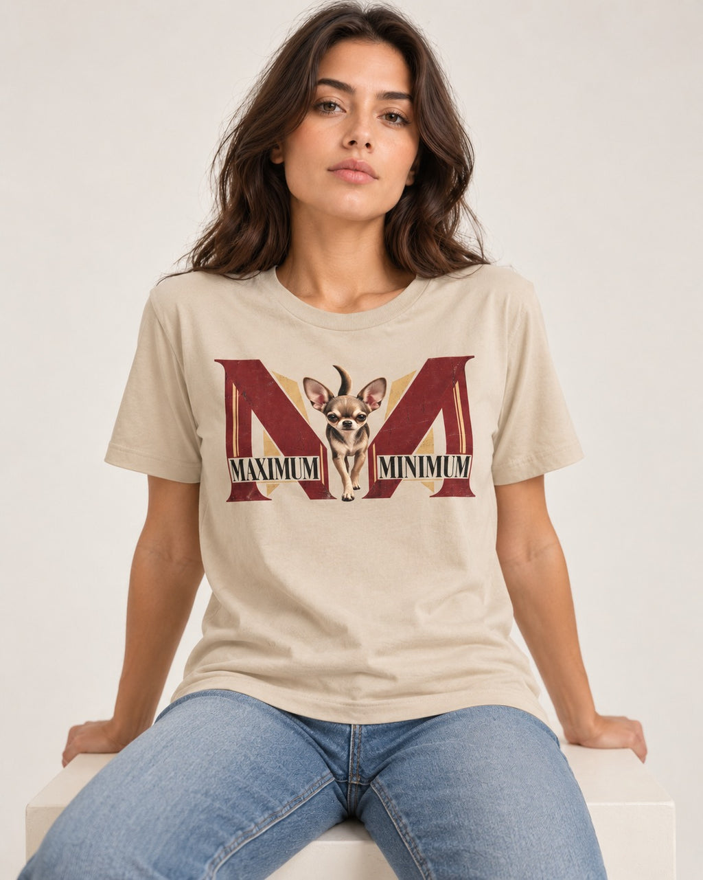 Maximum Minimum Chihuahua T-Shirt in Sand, worn by a seated model