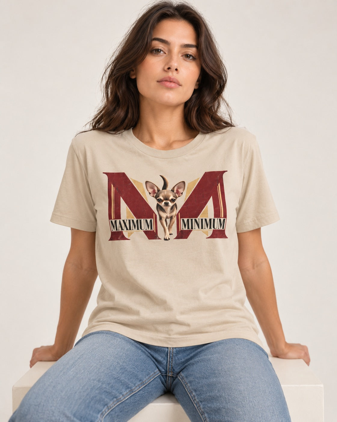 Maximum Minimum Chihuahua T-Shirt in Sand, worn by a seated model
