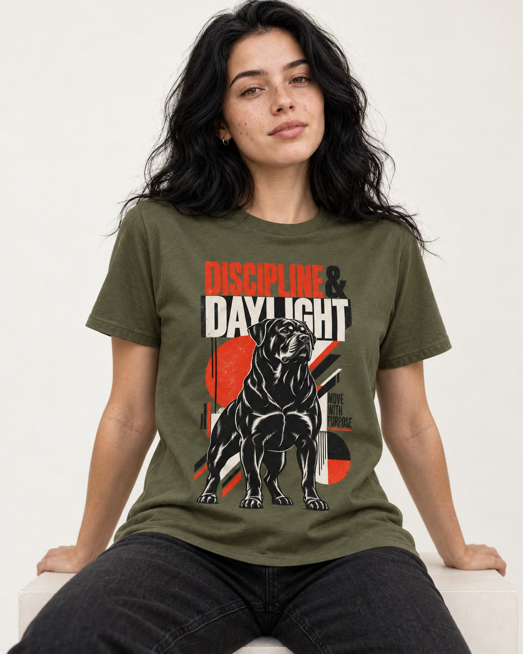 Discipline and Daylight Rottweiler Move With Purpose T-Shirt in Heather Military Green, worn by a seated model