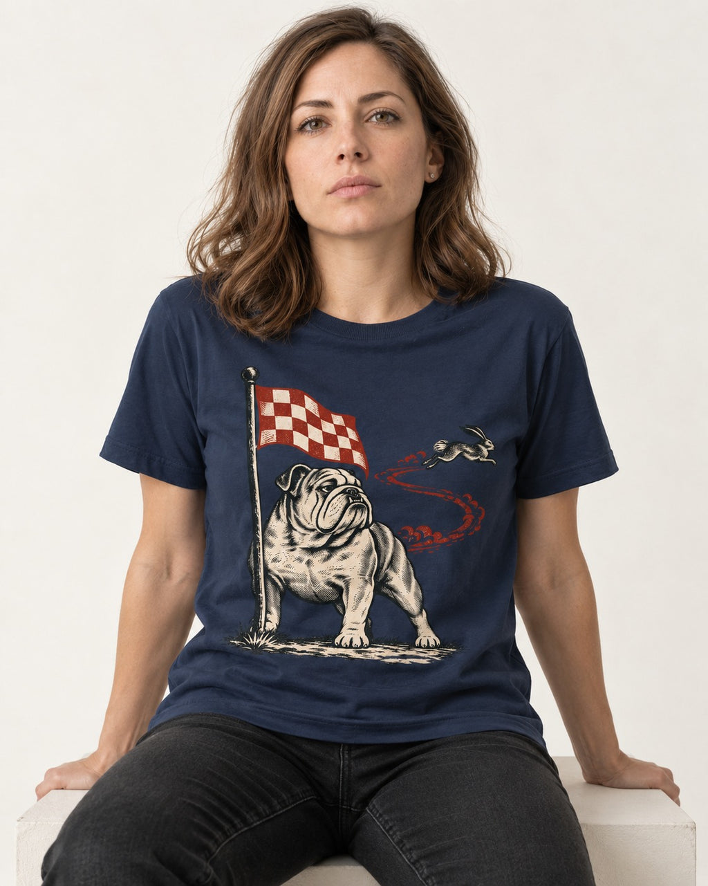 English Bulldog Checkered Flag Rabbit Chase T-Shirt in Navy, worn by a seated model