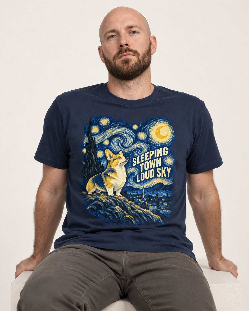 Corgi Sleeping Town Loud Sky Starry Night T-Shirt in Navy, worn by a seated model
