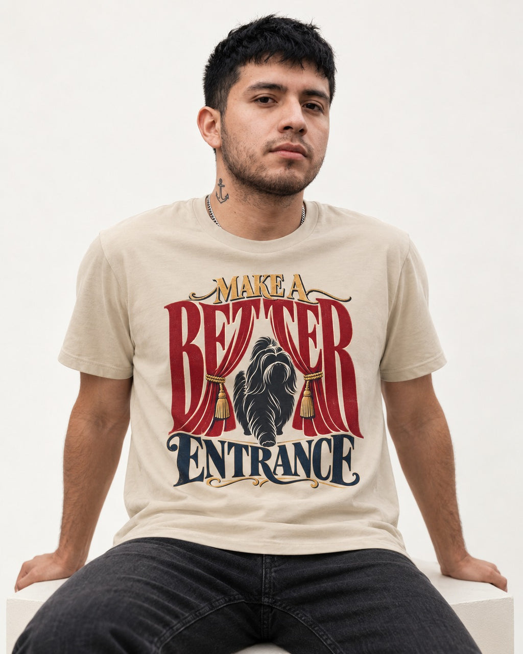 A Better Shih Tzu Entrance T-Shirt in Sand, worn by a seated model