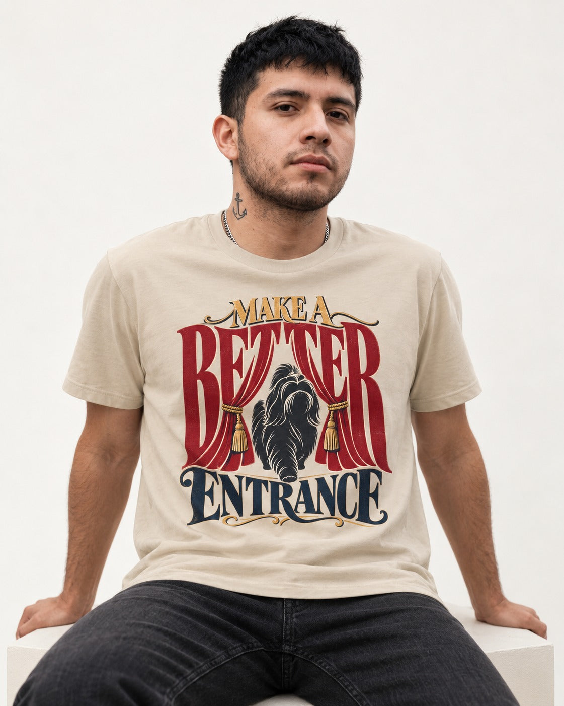 A Better Shih Tzu Entrance T-Shirt in Sand, worn by a seated model