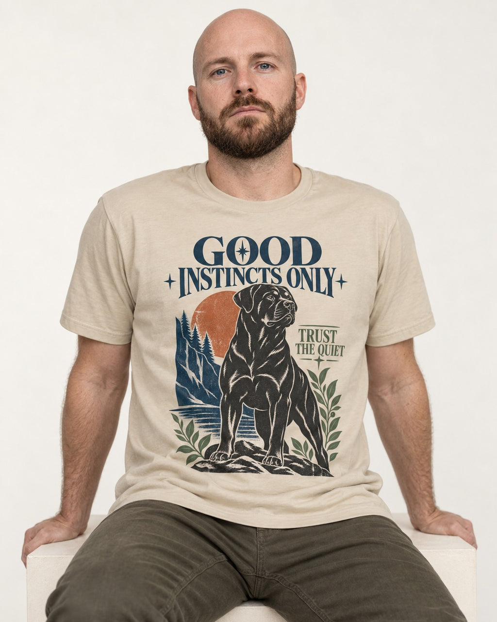 Good Instincts Only Rottweiler T-Shirt in Sand, worn by a seated model