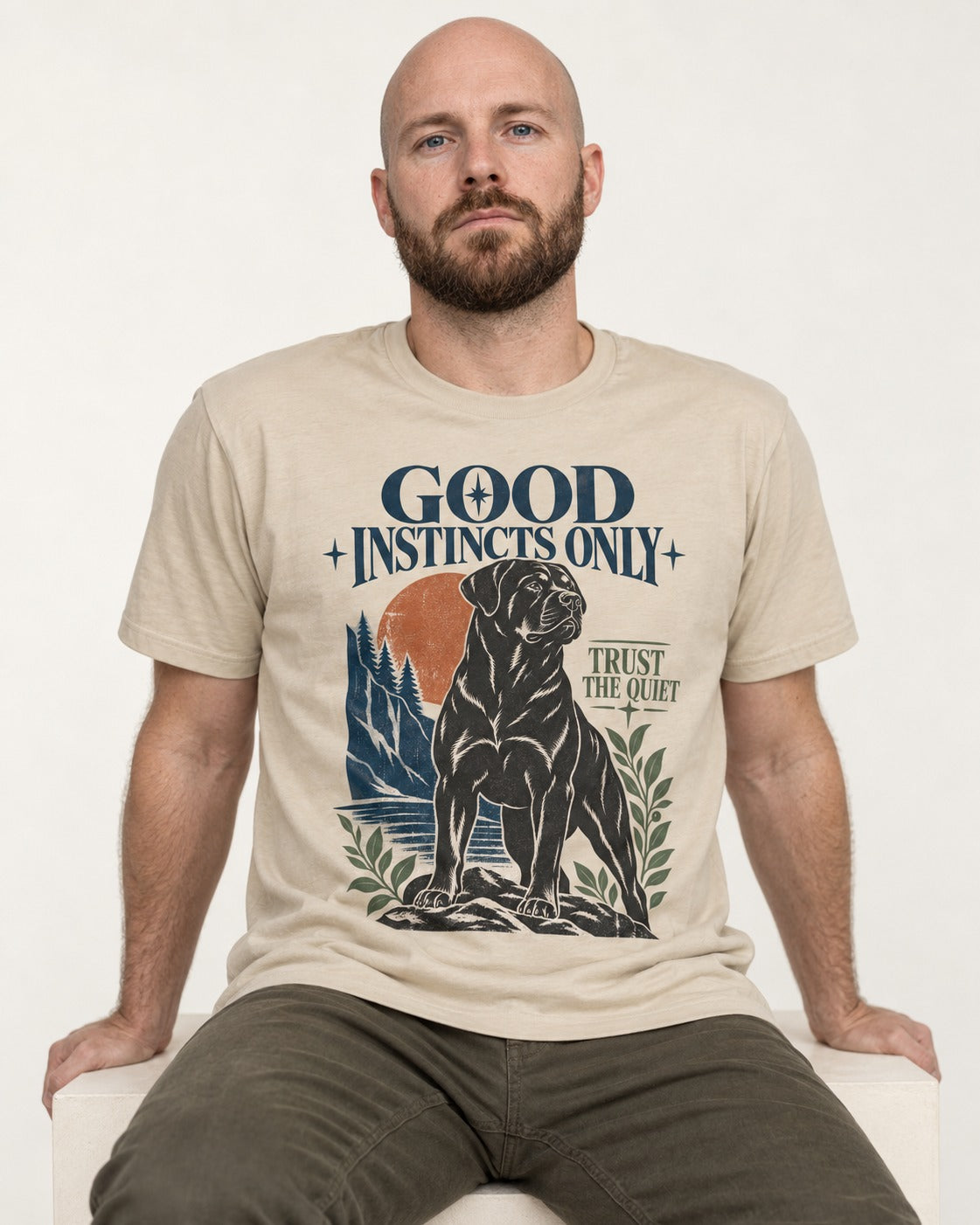 Good Instincts Only Rottweiler T-Shirt in Sand, worn by a seated model