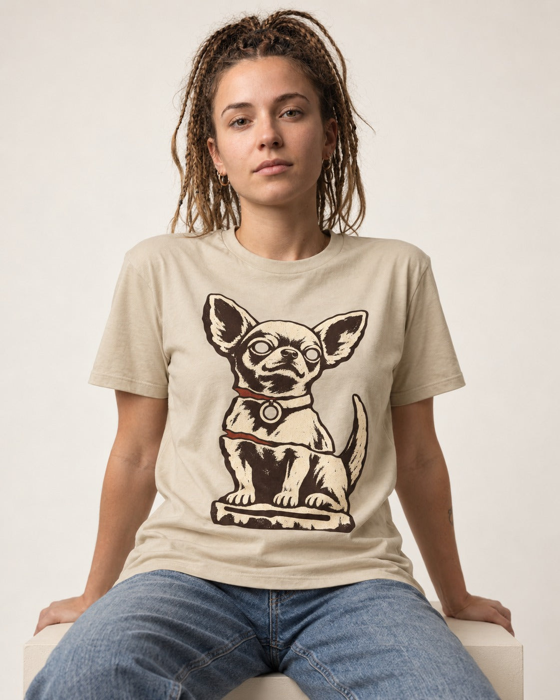 Chihuahua's Eternal Vigil T-Shirt in Sand, worn by a seated model