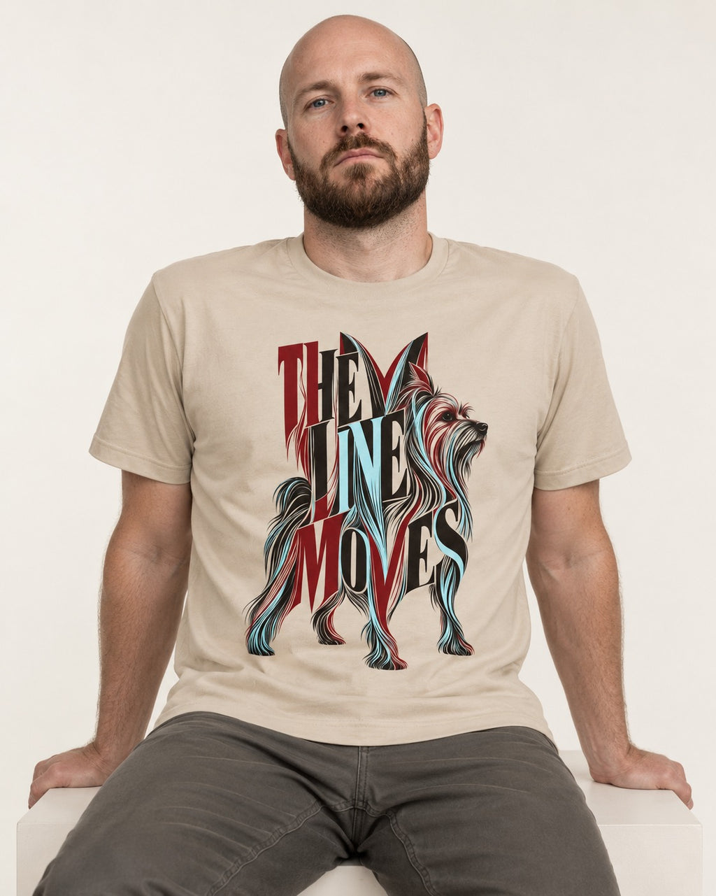 The One Moves Yorkshire Terrier T-Shirt in Sand, worn by a seated model