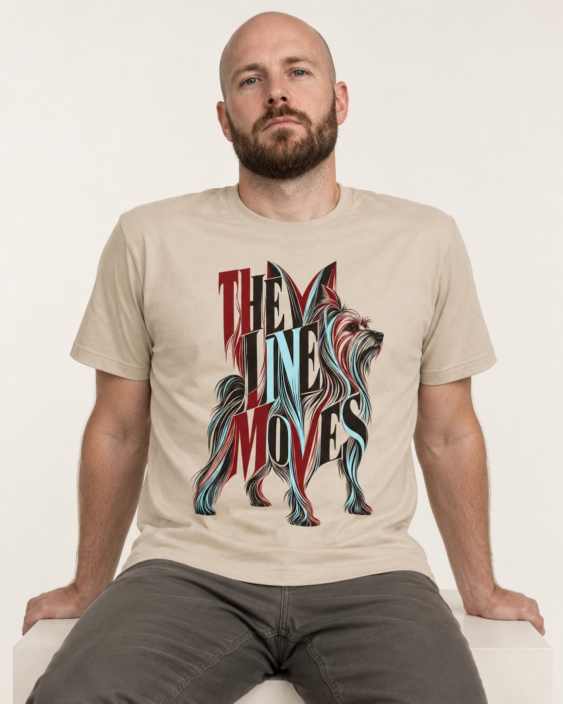 The One Moves Yorkshire Terrier T-Shirt in Sand, worn by a seated model