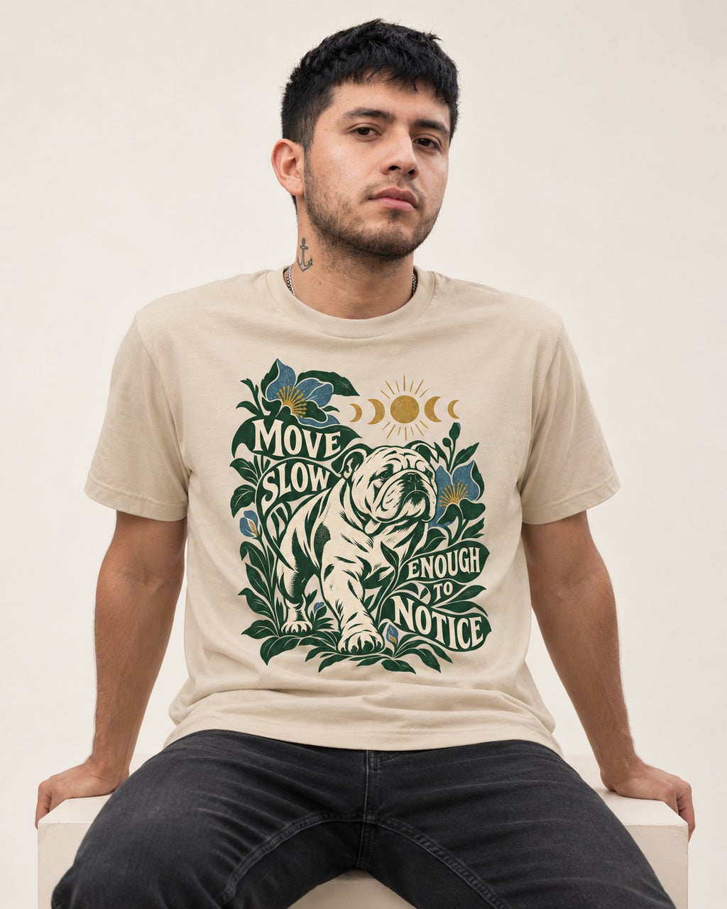 Move Slow English Bulldog T-Shirt in Sand, worn by a seated model