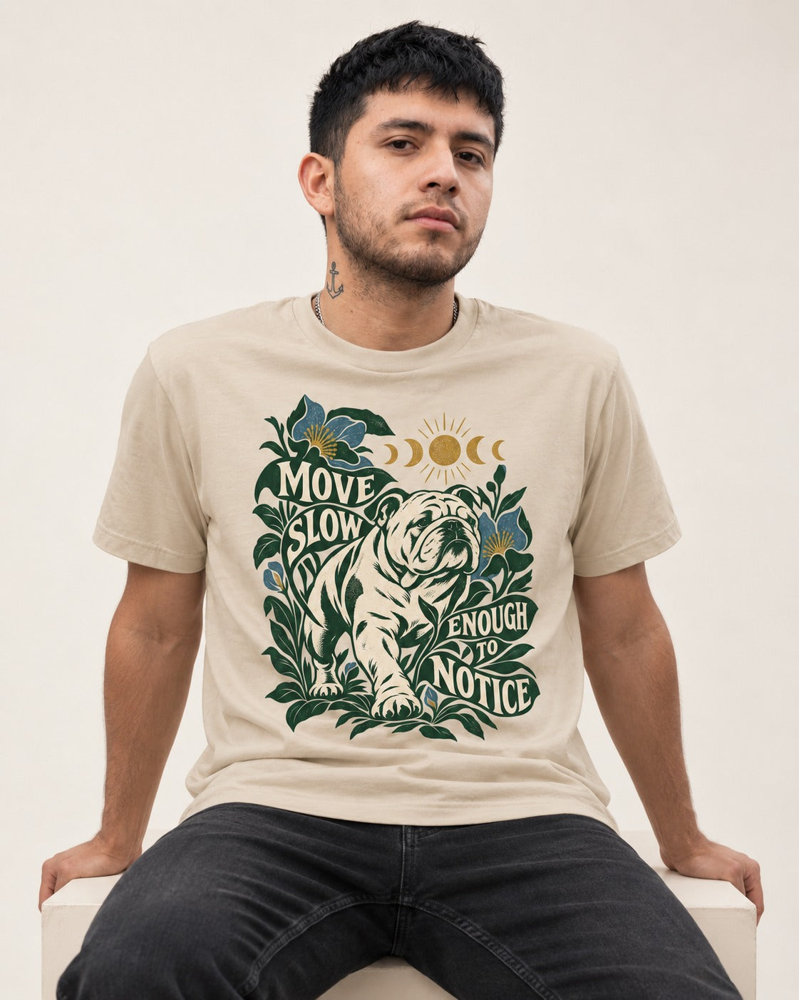Move Slow English Bulldog T-Shirt in Sand, worn by a seated model