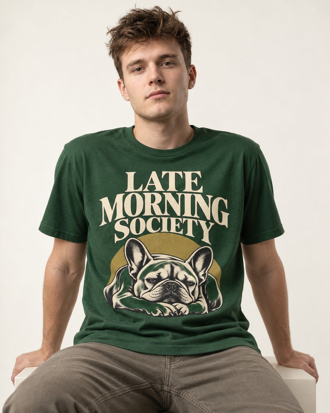 Frenchie Late Morning Society Graphic T-Shirt in Forest Green, worn by a seated model