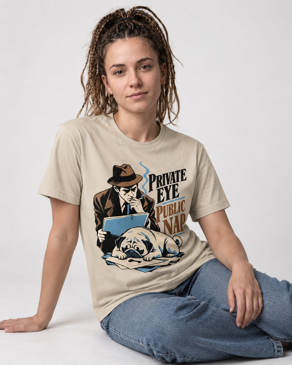 Pug Private Eye Public Nap T-Shirt in Sand, worn by a seated model
