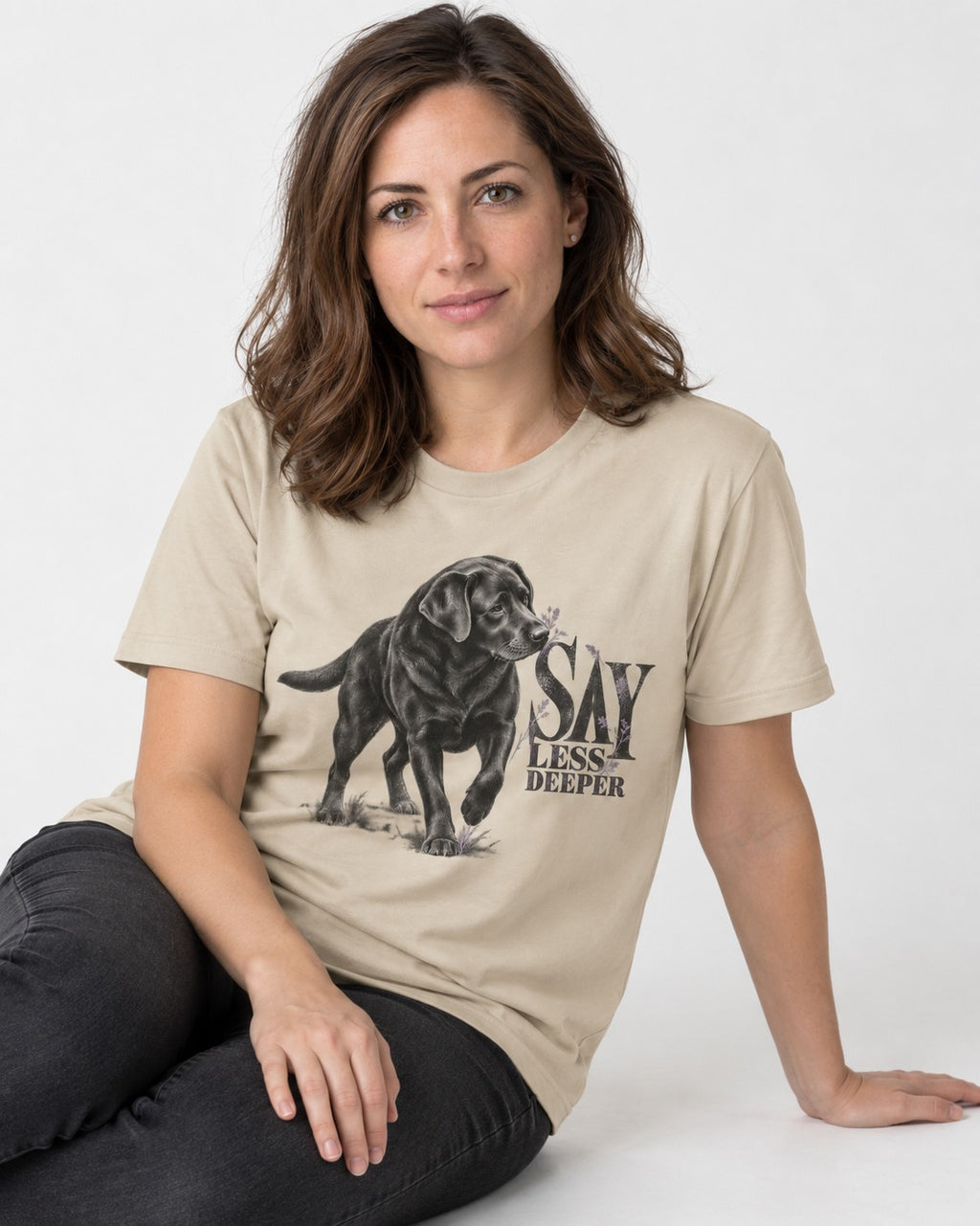 Say Less Deeper Labrador Retriever T-Shirt in Sand, worn by a seated model