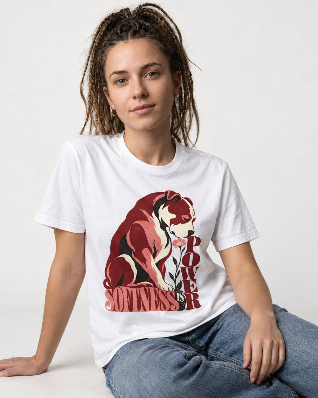 Pitbull Softness Is Power Flower Graphic T-Shirt in White, worn by a seated model