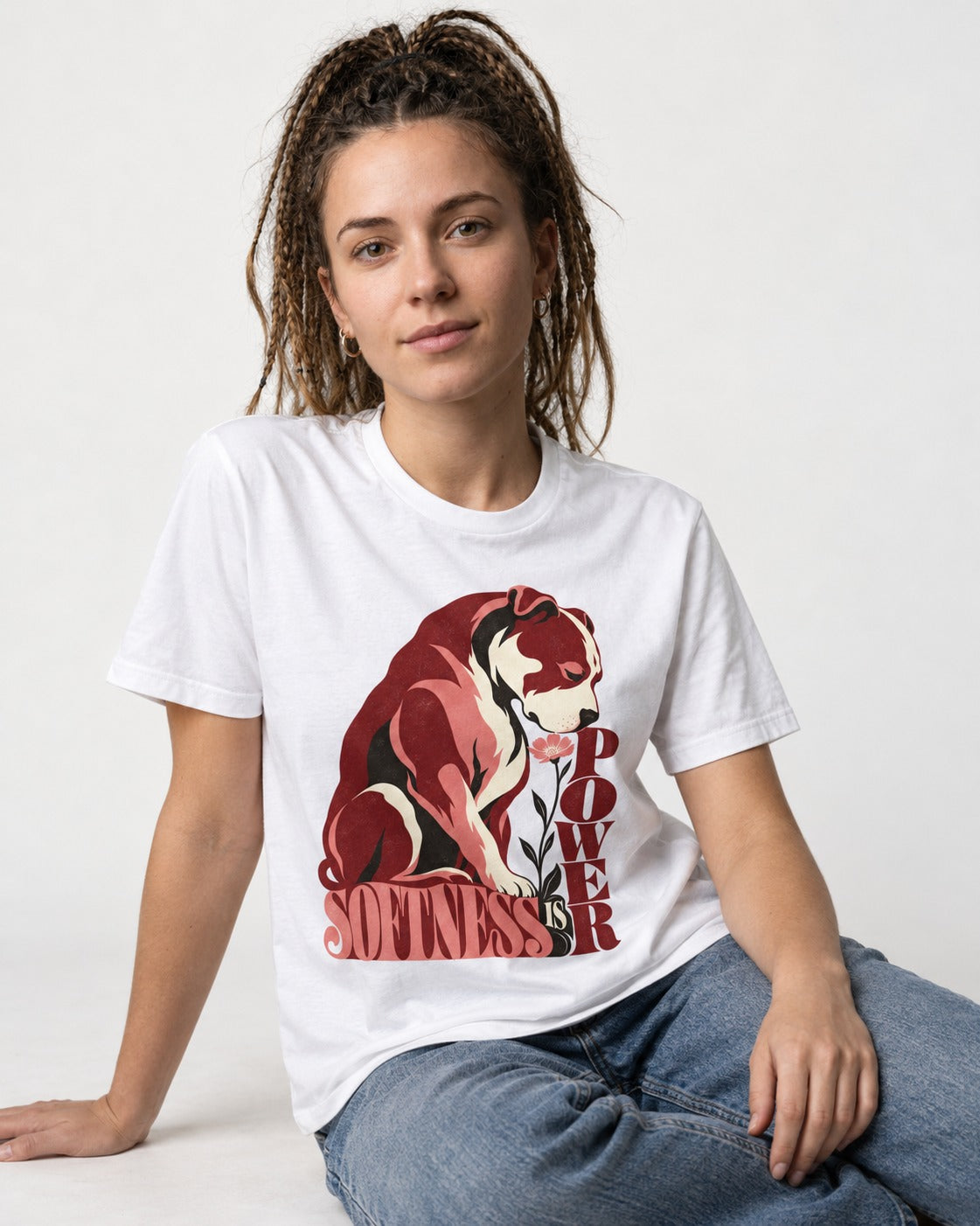 Pitbull Softness Is Power Flower Graphic T-Shirt in White, worn by a seated model