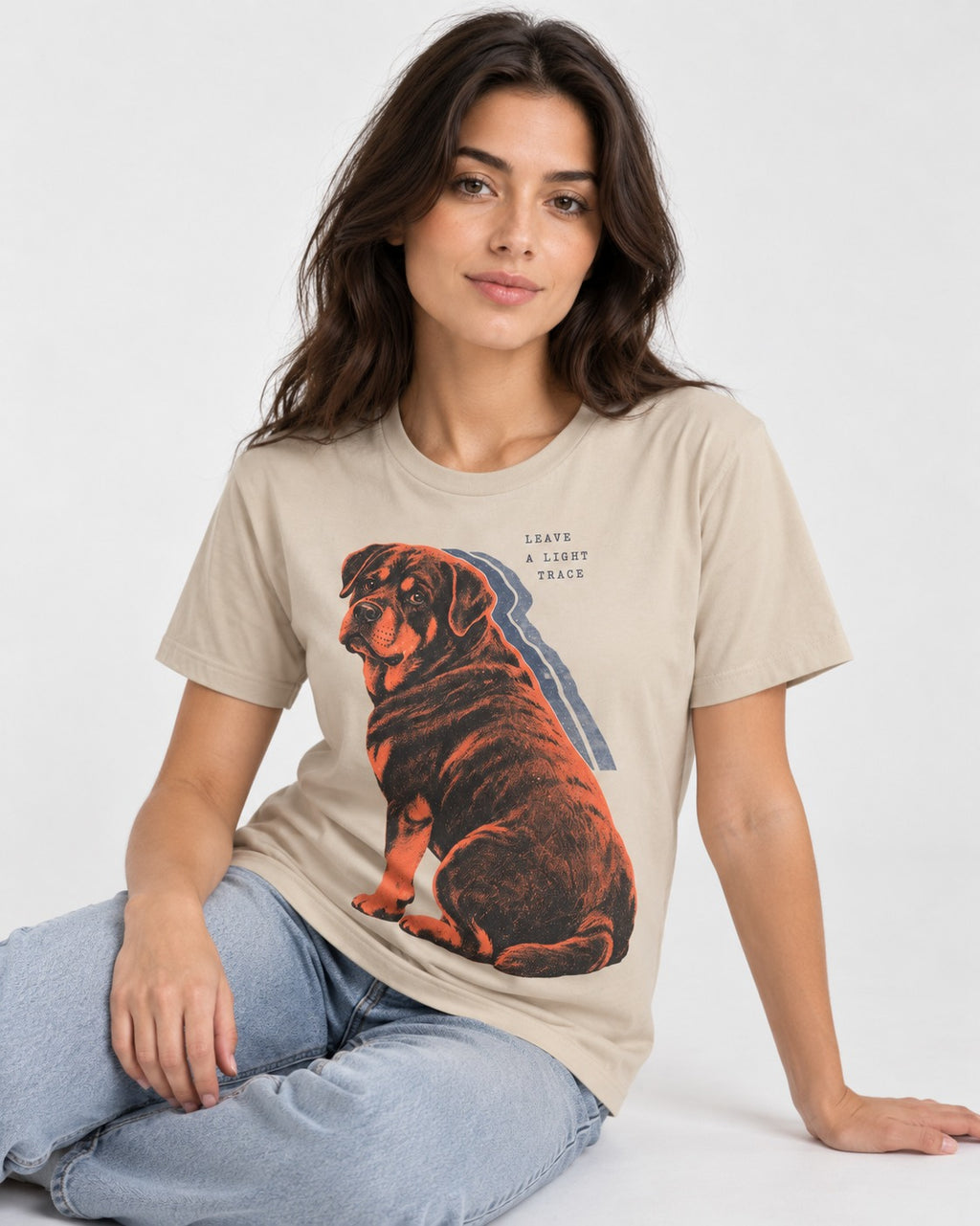 Rottweiler Leave a Light Trace T-Shirt in Sand, worn by a seated model