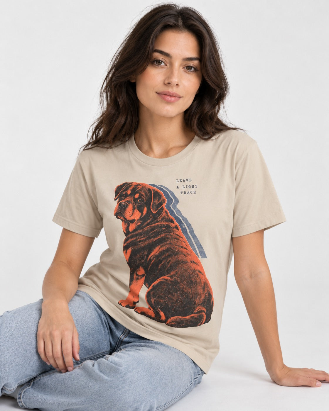 Rottweiler Leave a Light Trace T-Shirt in Sand, worn by a seated model