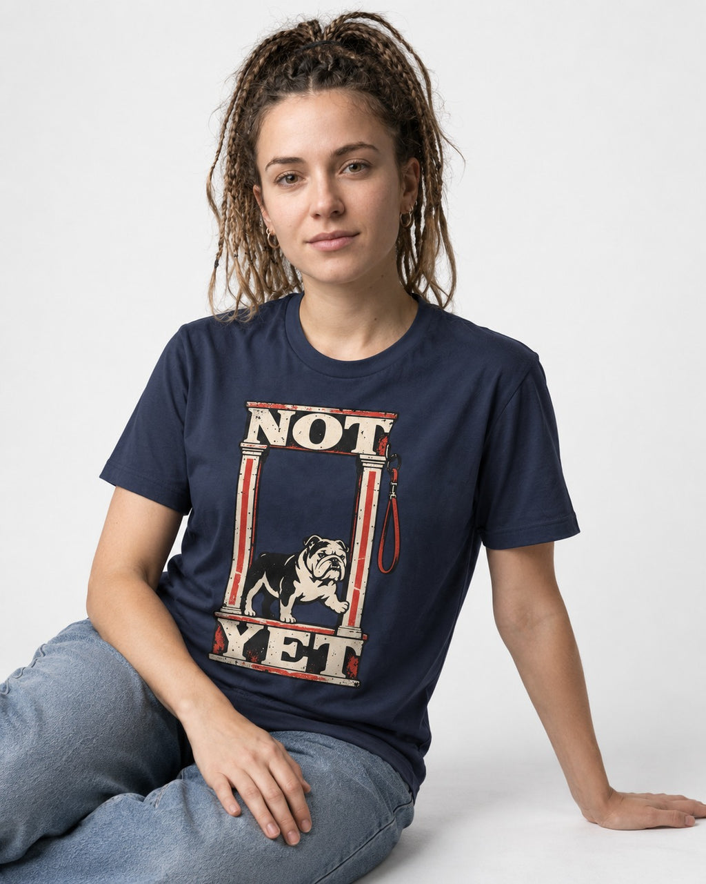 English Bulldog Not Yet Doorway Graphic T-Shirt in Navy, worn by a seated model