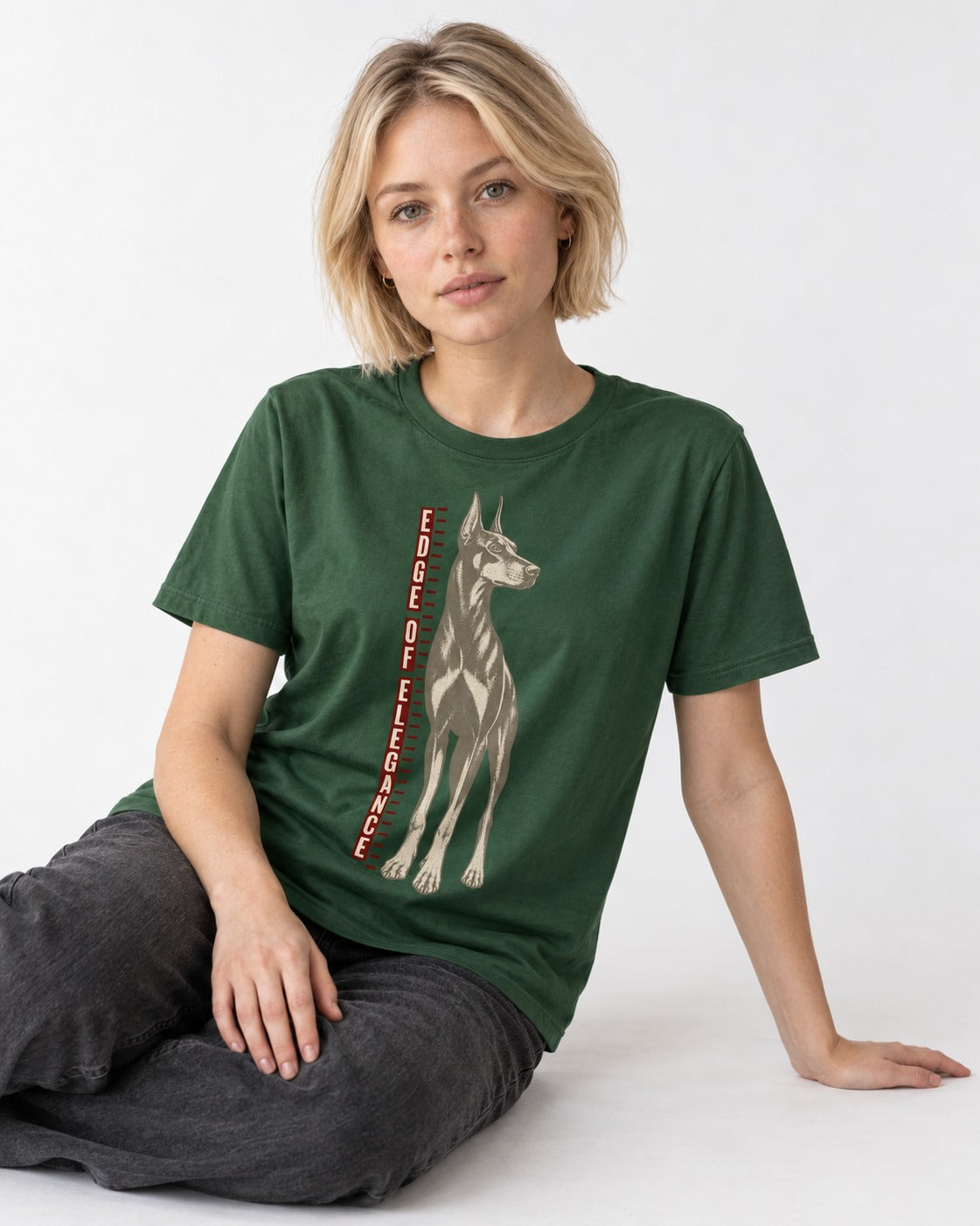 Doberman Edge of Elegance Height Chart Graphic T-Shirt in Forest Green, worn by a seated model