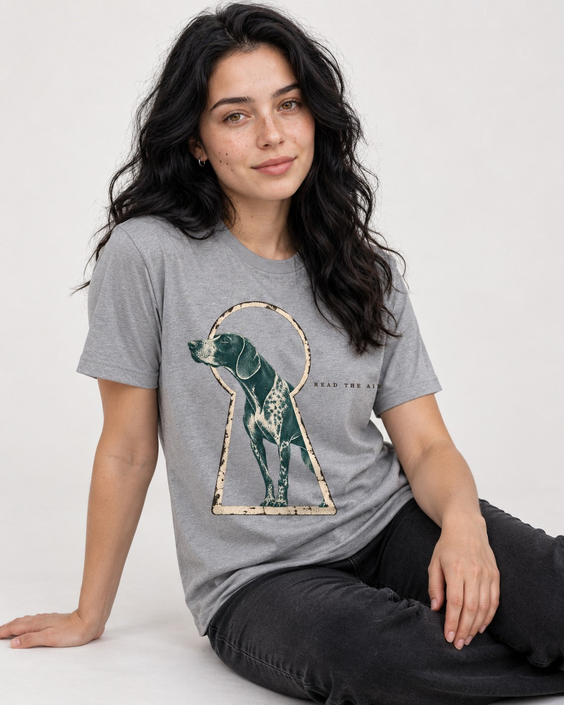 Read the Air German Shorthaired Pointer T-Shirt in Sport Grey, worn by a seated model