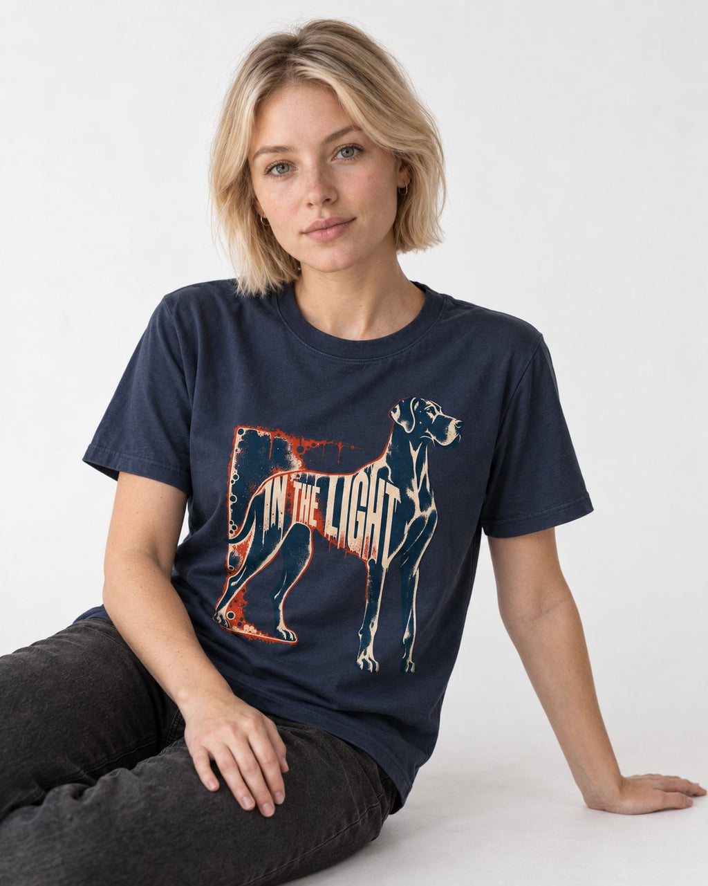 Great Dane In the Light Industrial Frame Graphic T-Shirt in Navy, worn by a seated model