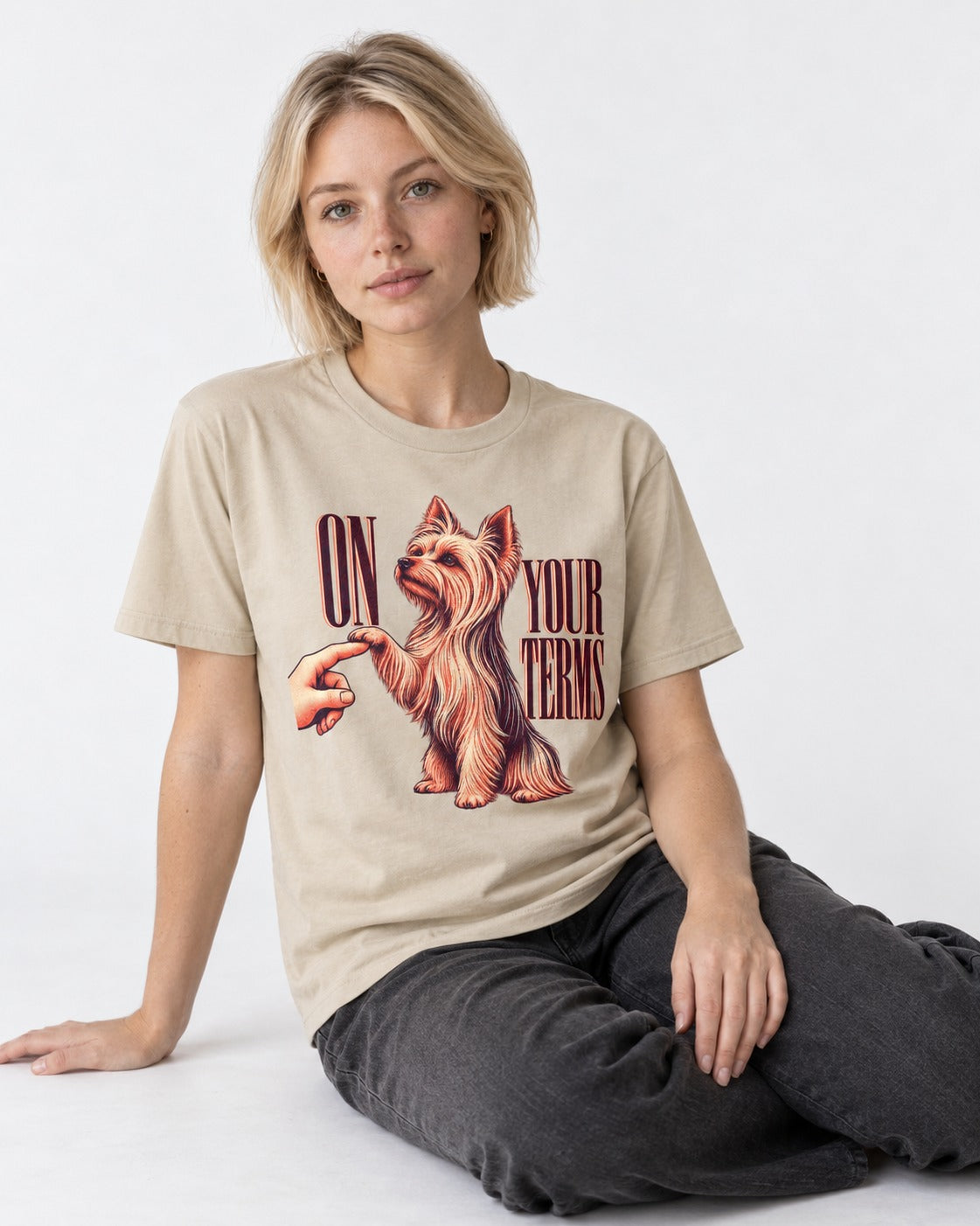 Yorkshire Terrier On Your Terms T-Shirt in Sand, worn by a seated model
