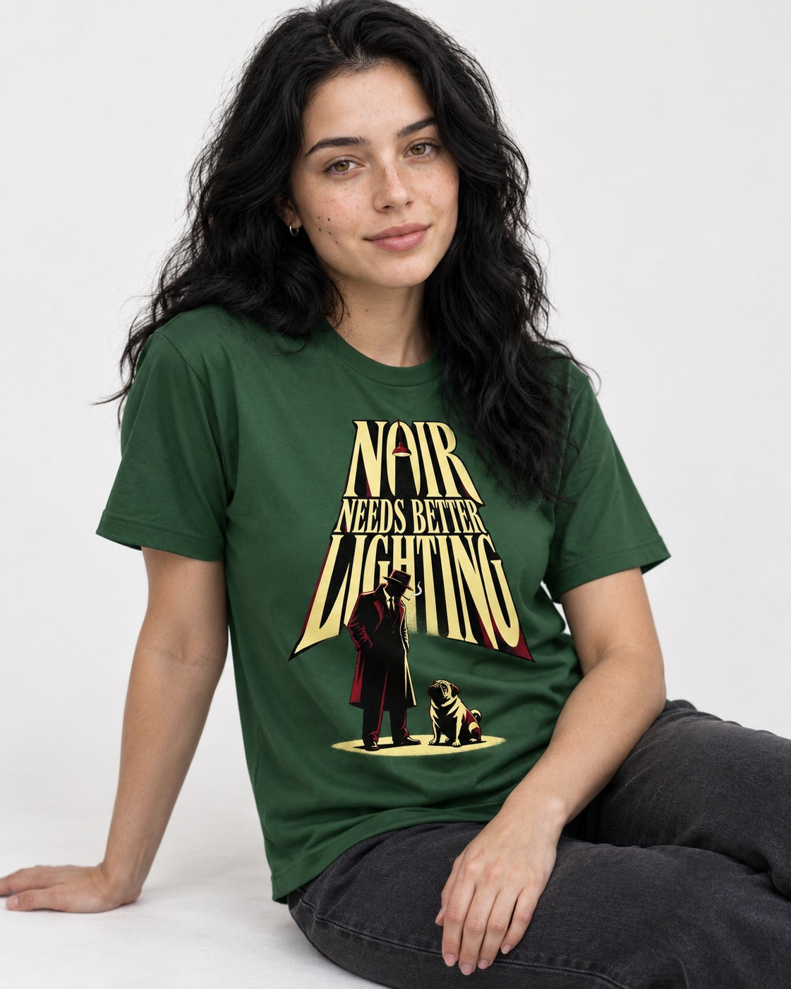 Pug Noir Needs Better Lighting Detective Graphic T-Shirt in Forest Green, worn by a seated model