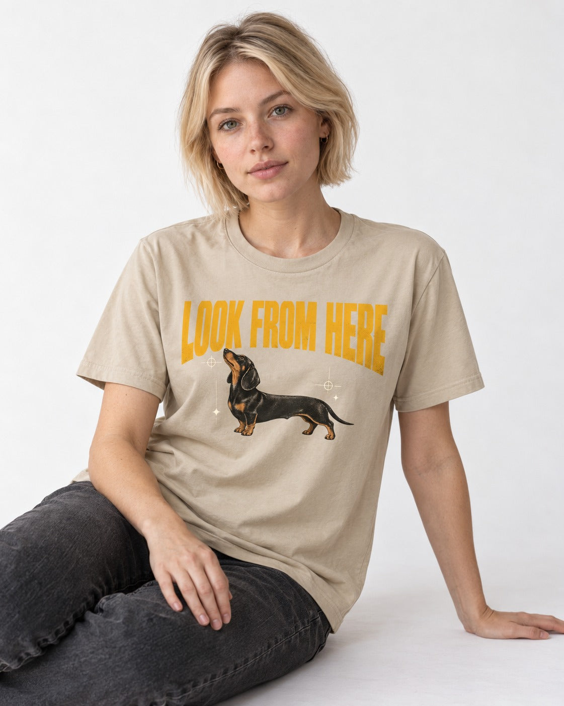 Dachshund Look From Here T-Shirt in Sand, worn by a seated model