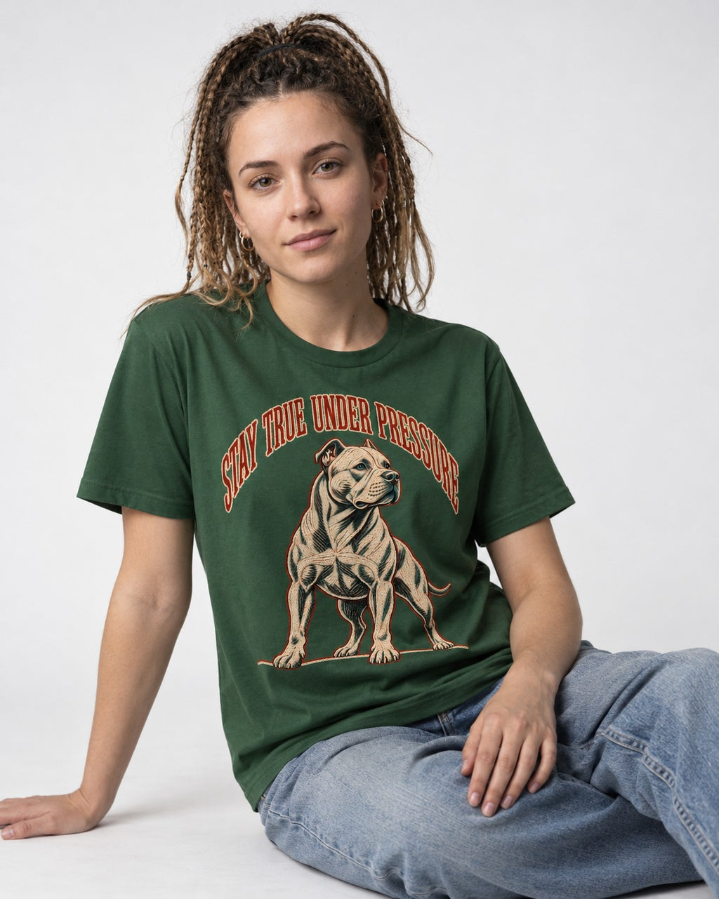 Pitbull Stay True Under Pressure Stance Graphic T-Shirt in Forest Green, worn by a seated model