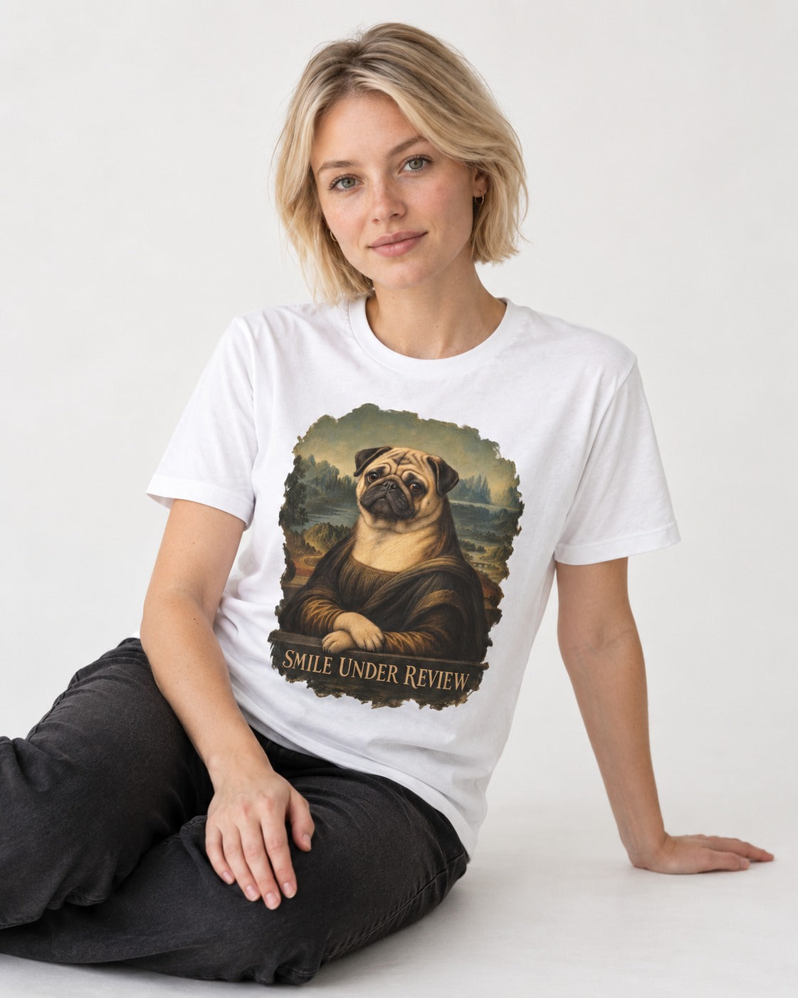Pug Smile Under Review Mona Lisa Graphic T-Shirt in White, worn by a seated model