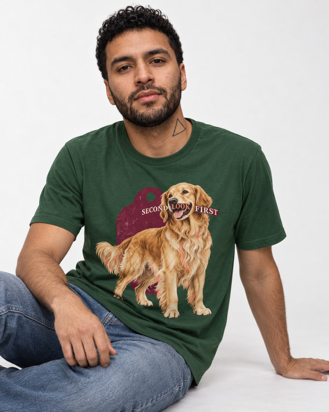 Golden Retriever Second Look First Tag Portrait Graphic T-Shirt in Forest Green, worn by a seated model