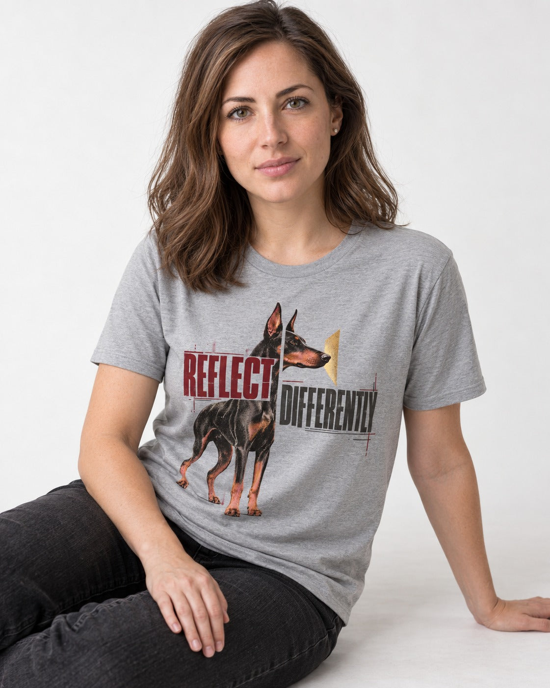 Doberman Reflects Differently T-Shirt in Sport Grey, worn by a seated model