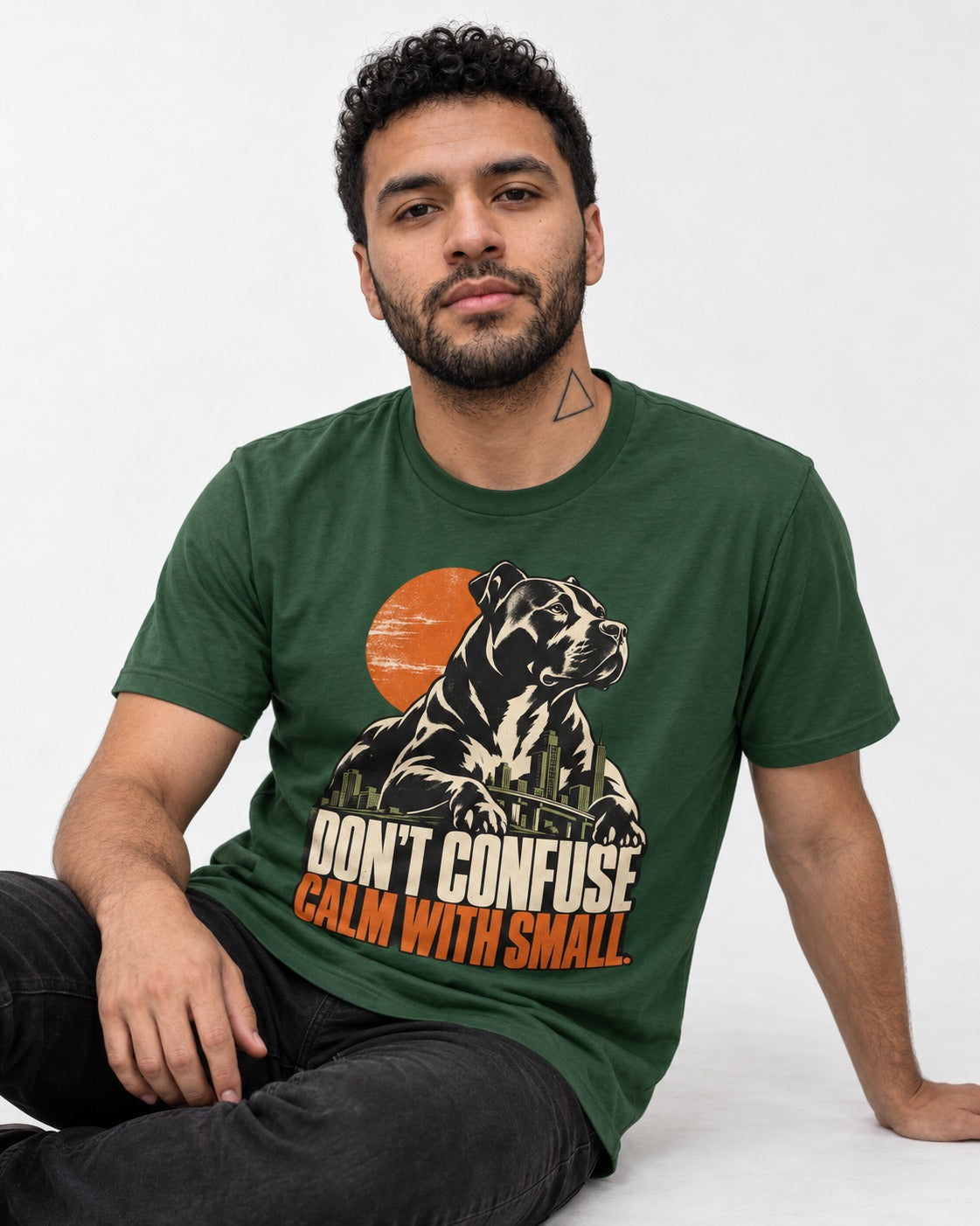 Pitbull Don't Confuse Calm with Small City Guardian Graphic T-Shirt in Forest Green, worn by a seated model