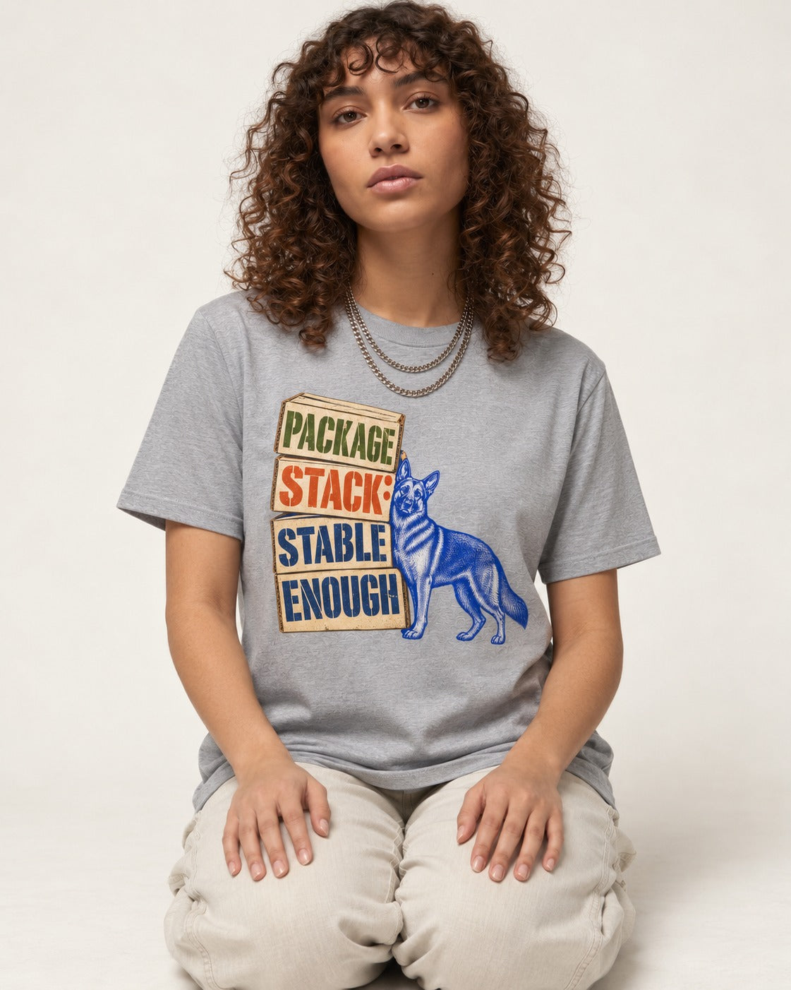 Package Stack Stable Enough German Shepherd Dog T-Shirt in Sport Grey, worn by a seated model