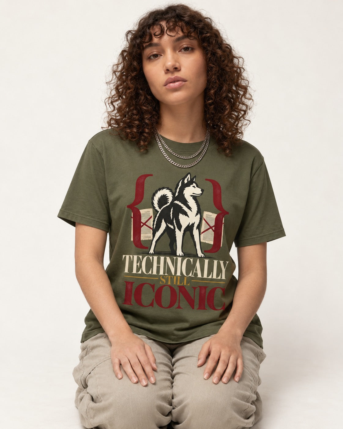 Husky Technically Still Iconic Editorial Frame Graphic T-Shirt in Heather Military Green, worn by a seated model