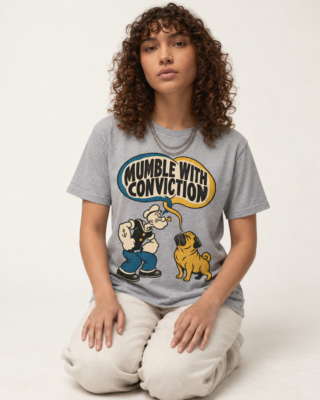 Pug Mumble with Conviction T-Shirt in Sport Grey, worn by a seated model
