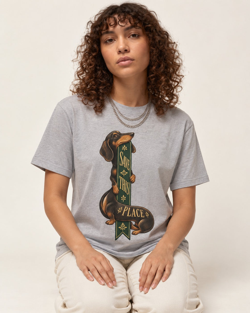 Save This Place Dachshund T-Shirt in Sport Grey, worn by a seated model