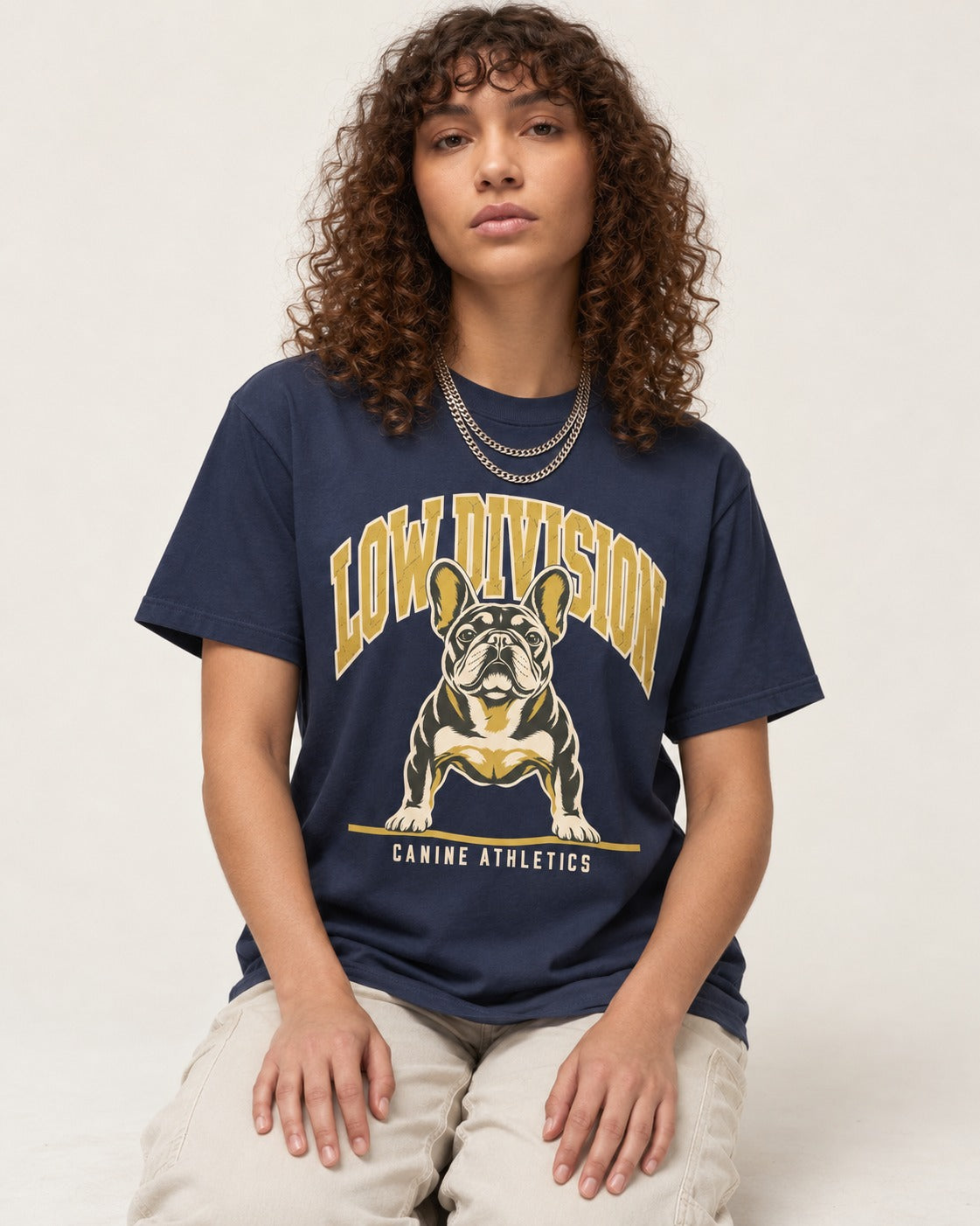 Frenchie Low Division Canine Athletics Graphic T-Shirt in Navy, worn by a seated model