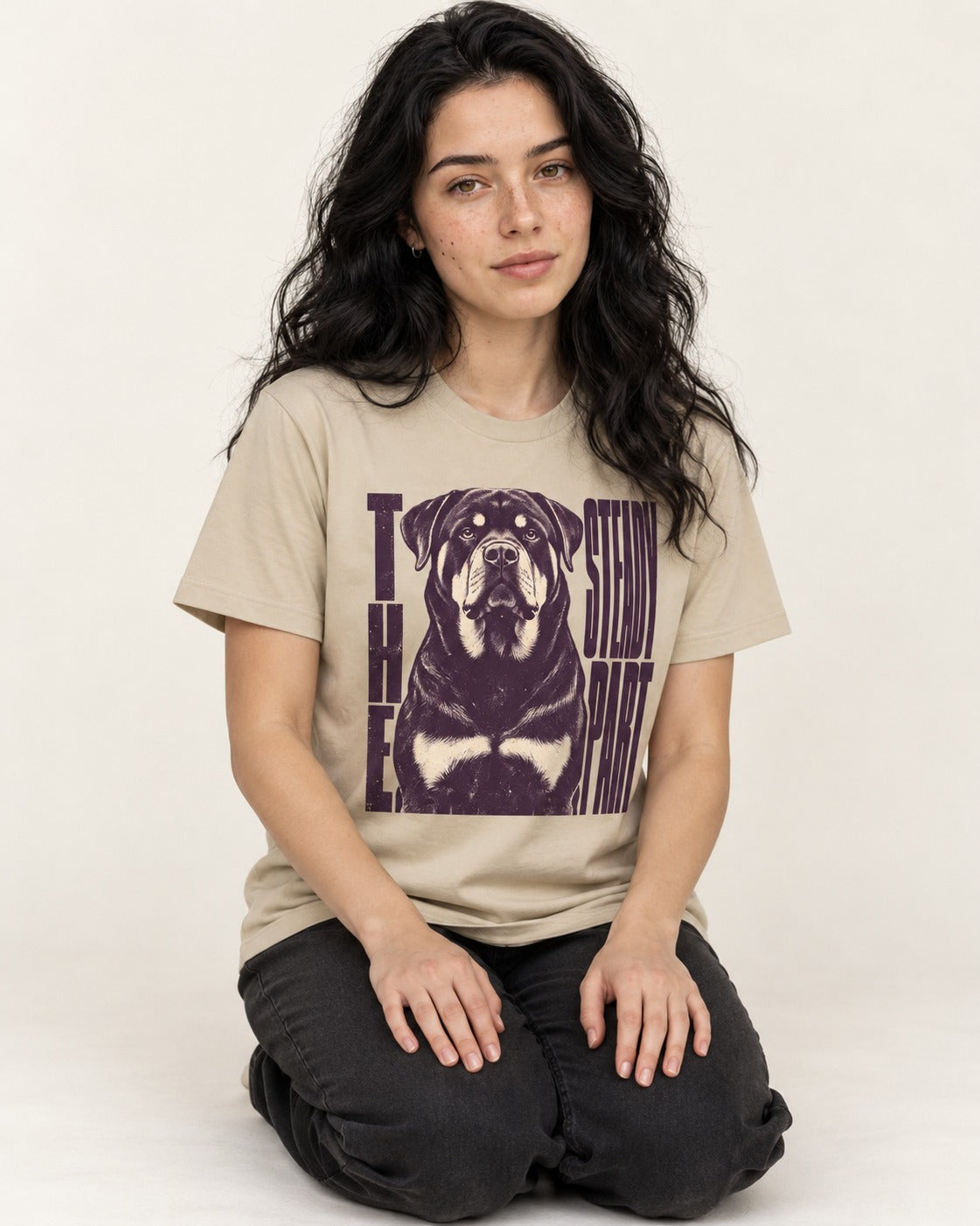 Rottweiler The Steady Part T-Shirt in Sand, worn by a seated model