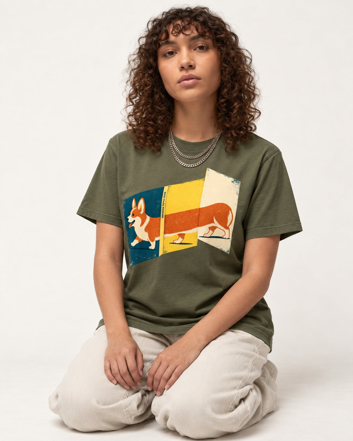 Corgi Back Folds Forward Panels T-Shirt in Heather Military Green, worn by a seated model