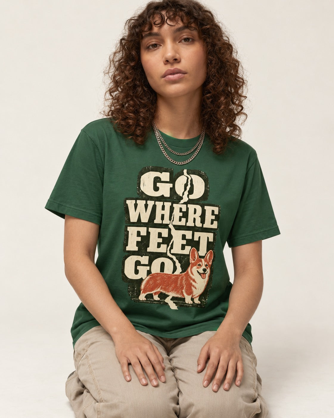 Corgi Go Where Feet Go Path T-Shirt in Forest Green, worn by a seated model
