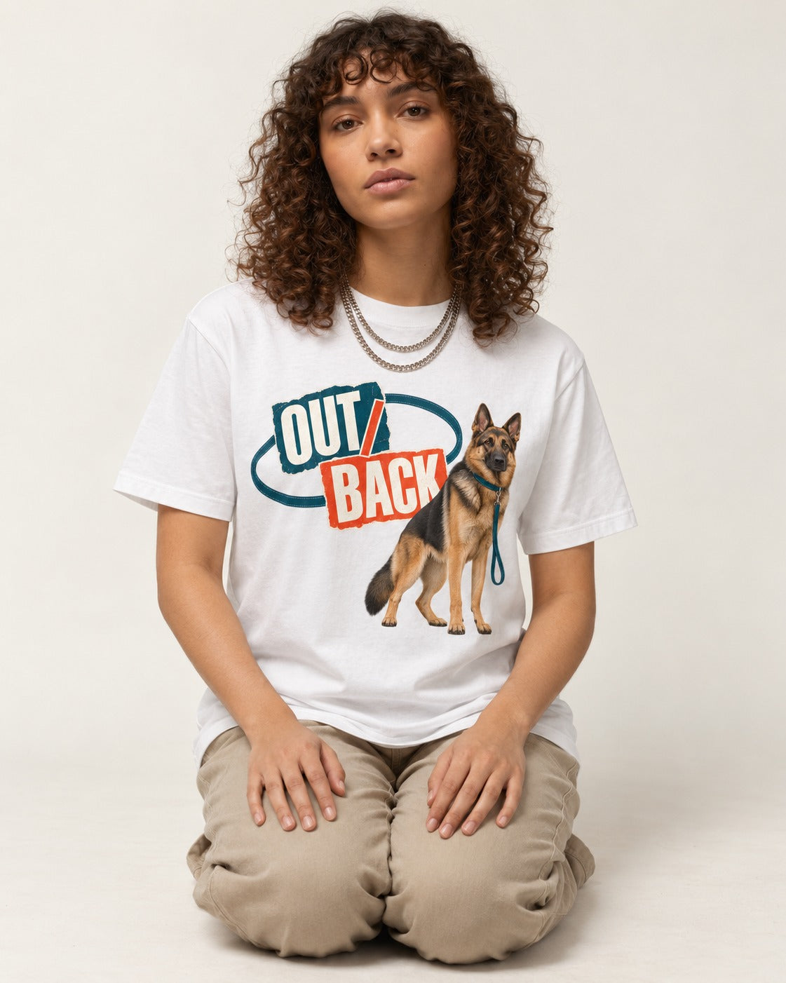 Out Back Leash German Shepherd Dog Graphic T-Shirt in White, worn by a seated model